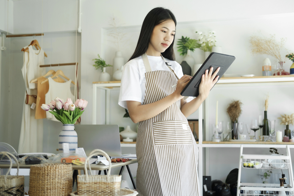 Small business owner checking local marketing strategy on a tablet