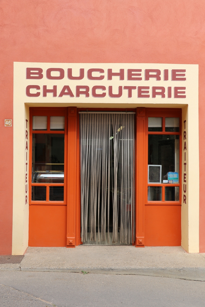 Artisan butcher shop storefront in Roussillon Front of an artisan butcher shop in Roussillon, France