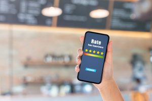 Customer leaving a Google review for a San Francisco business on a phone