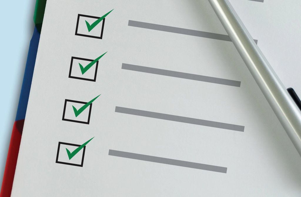 Checklist on a clipboard with a pen for auditing local business listings