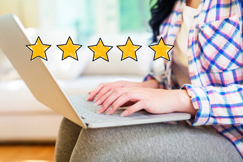 Small business owner replying to Google reviews on a laptop
