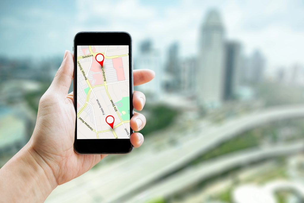 Smartphone showing a map with location pins for local business listings